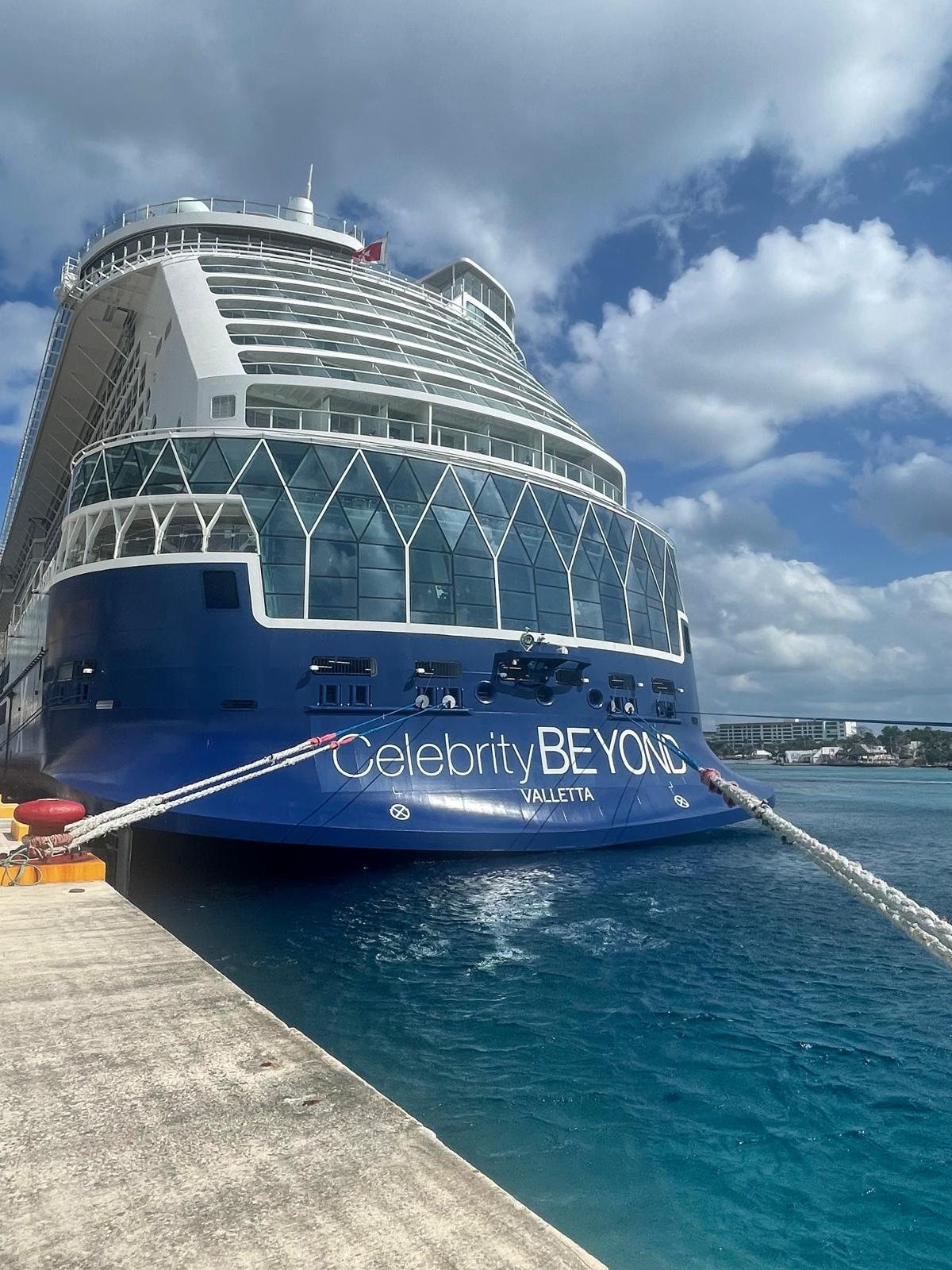 The bow of the Celebrity Beyond alongside a pier, with the ship name visible on the hull