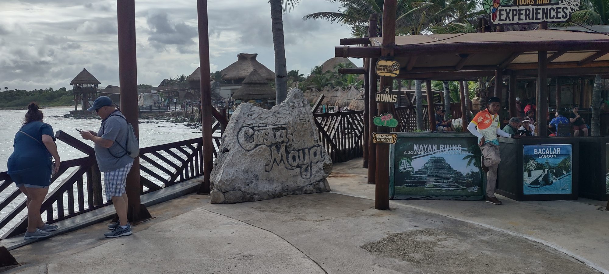 The entrance to the Costa Maya port complex, with the carved Costa Maya sign and tour desks