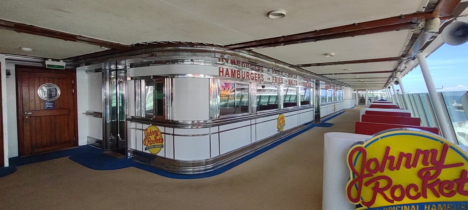A Johnny Rockets diner on the deck of a Royal Caribbean ship, chrome counter and red booths