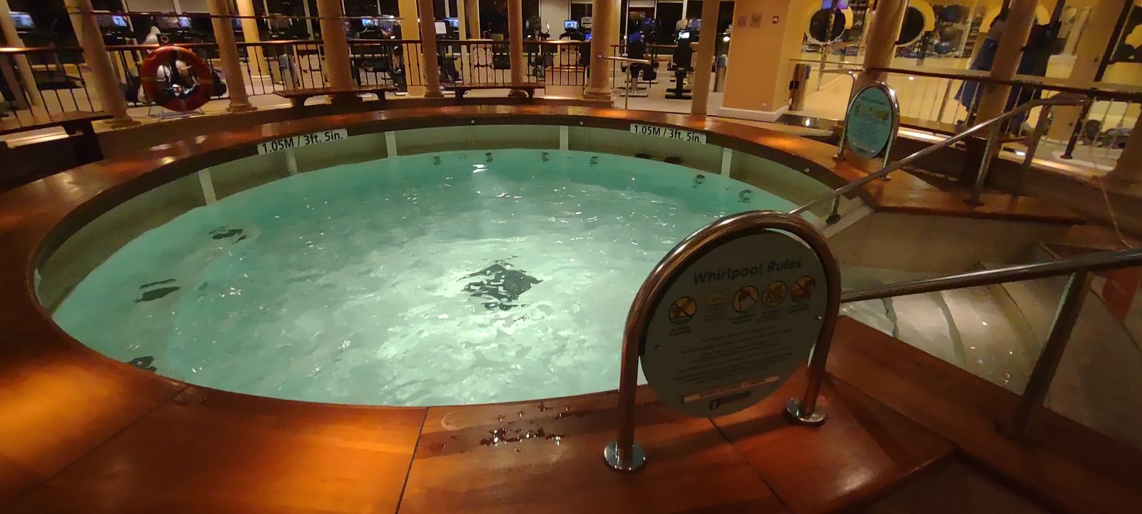 A lit whirlpool on a quiet cruise ship deck at night